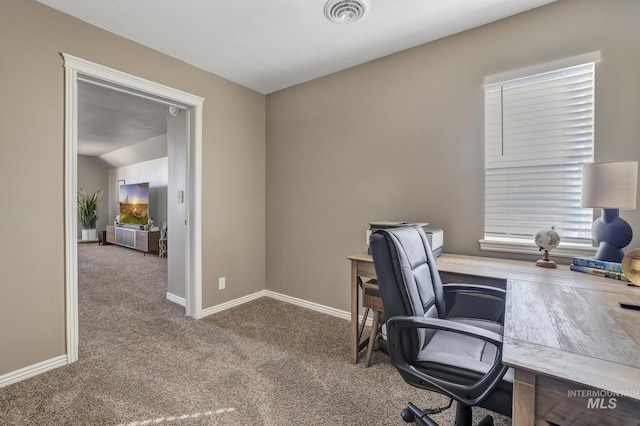 carpeted home office with visible vents, vaulted ceiling, and baseboards