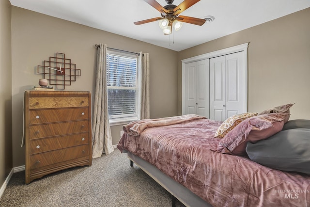 bedroom with a ceiling fan, carpet, a closet, and baseboards