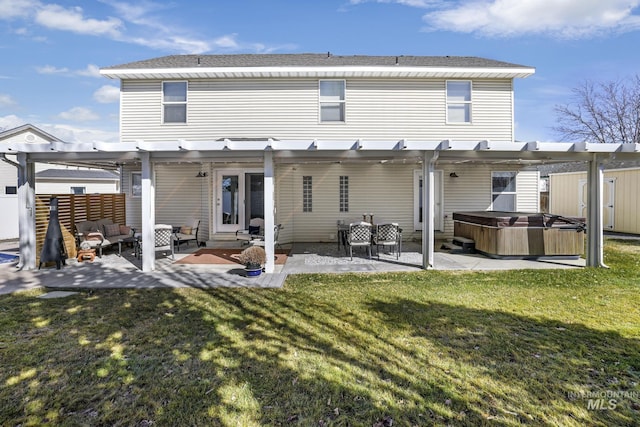 back of house with outdoor lounge area, a lawn, a pergola, a patio area, and a hot tub