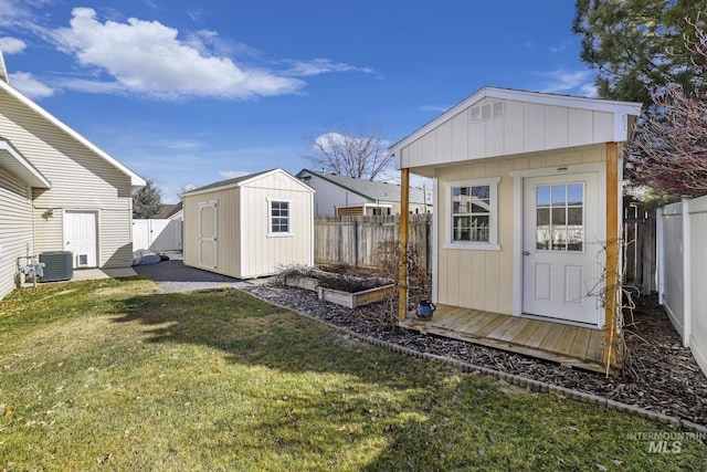 view of shed featuring a garden, a fenced backyard, and central AC