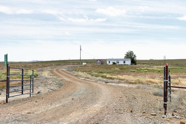 11755 E Cleft Rd, Mountain Home, ID 83647 - view of dirt / gravel driveway with a view of rural / pastoral area and a gated entry