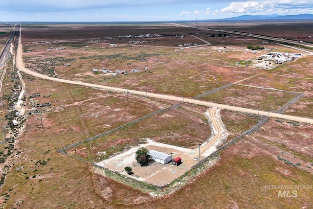 11755 E Cleft Rd, Mountain Home, ID 83647 - aerial overview of property's location with a mountain backdrop and rural landscape