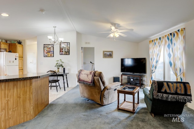 11755 E Cleft Rd, Mountain Home, ID 83647 - carpeted living area featuring lofted ceiling, ceiling fan, and a chandelier
