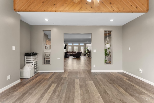 empty room with recessed lighting, wood finished floors, and baseboards