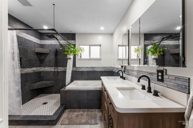 full bathroom with a sink and a tile shower