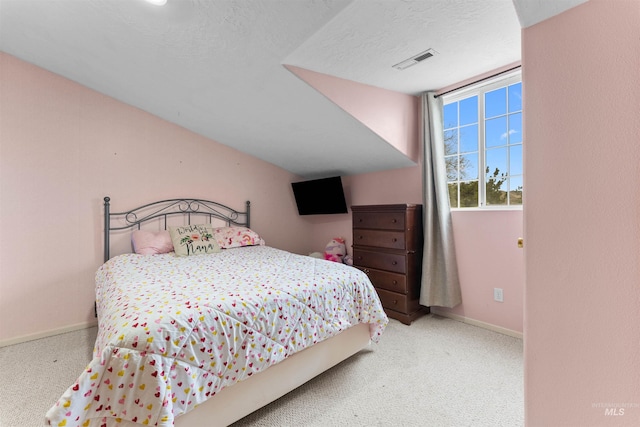 bedroom featuring visible vents, baseboards, carpet, and a textured ceiling