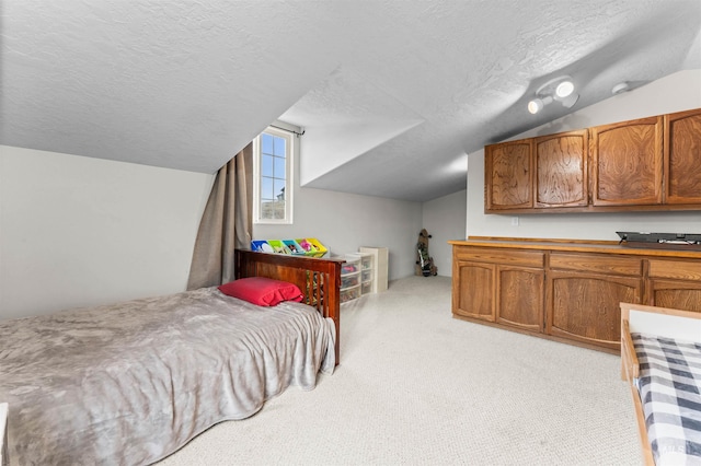 bedroom featuring light colored carpet, a textured ceiling, and vaulted ceiling