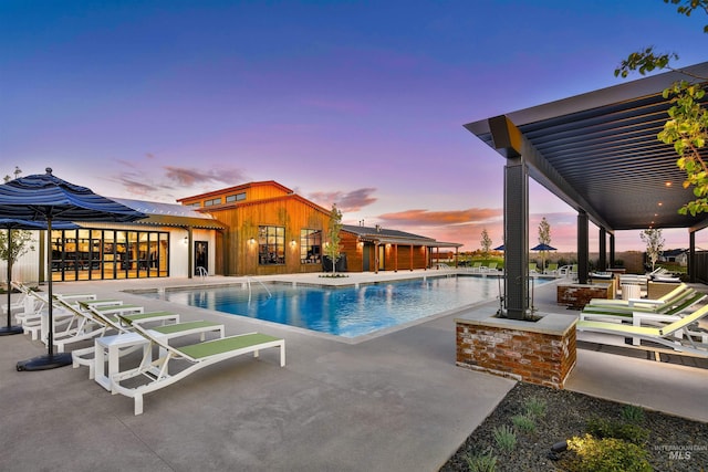 11801 W Reining Horse Ln, Kuna, ID 83634 - pool at dusk with a community pool and a patio