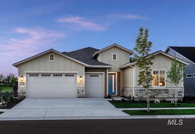 11801 W Reining Horse Ln, Kuna, ID 83634 - view of front of house with stone siding, board and batten siding, a garage, concrete driveway, and roof with shingles
