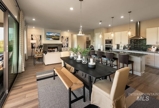 11801 W Reining Horse Ln, Kuna, ID 83634 - dining area featuring light wood finished floors, a tile fireplace, and recessed lighting