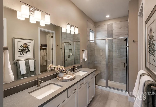 11801 W Reining Horse Ln, Kuna, ID 83634 - bathroom with a shower stall, double vanity, a walk in closet, and recessed lighting