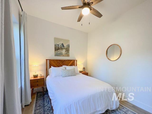 bedroom featuring a ceiling fan and wood finished floors