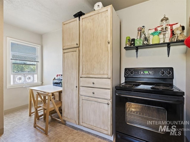 kitchen with light brown cabinets, black electric range oven, and baseboards