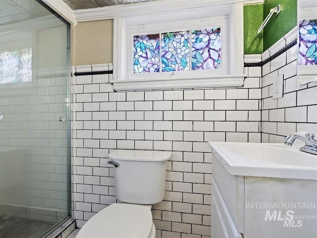 bathroom featuring plenty of natural light, tile walls, and a stall shower
