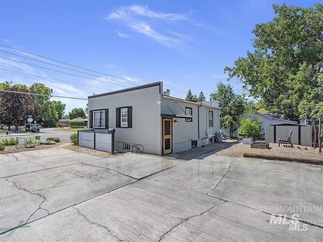 view of front of house with stucco siding and a patio