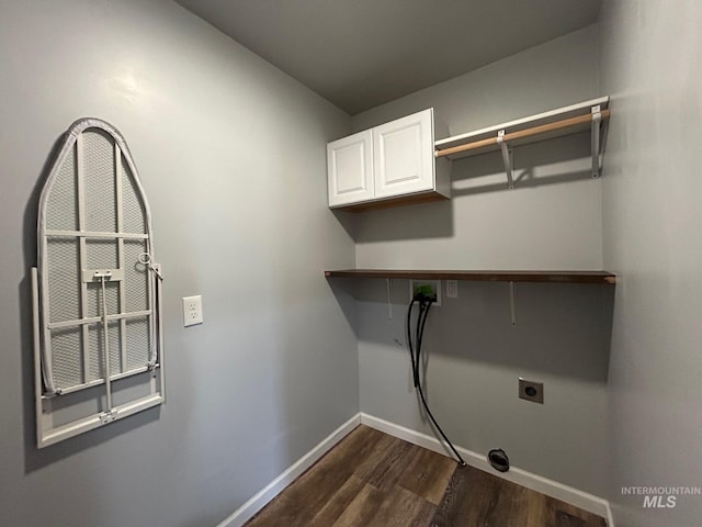 laundry area with dark wood-type flooring, washer hookup, and cabinets