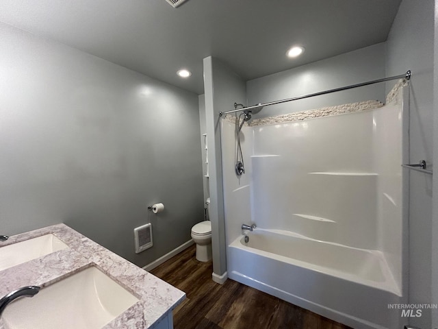 full bathroom featuring hardwood / wood-style flooring, shower / bathing tub combination, toilet, and vanity