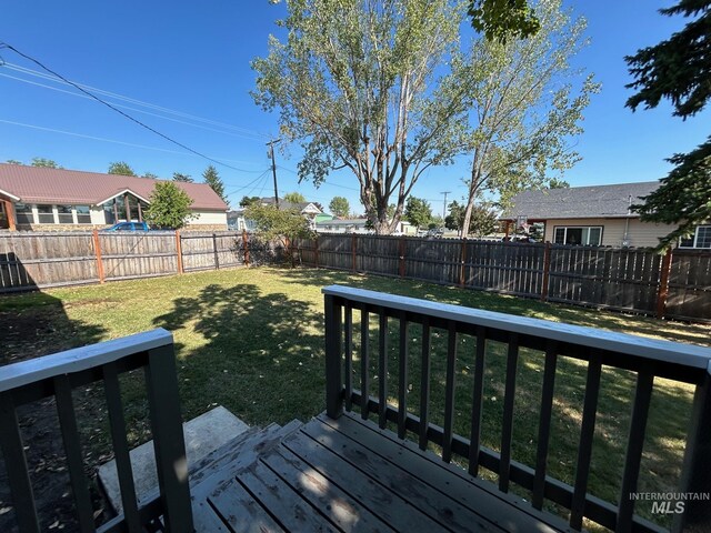 wooden deck with a lawn