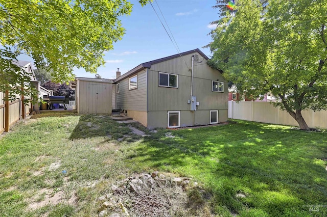 168 W Heyburn Ave, Twin Falls, ID 83301 - rear view of property with a fenced backyard and a storage shed