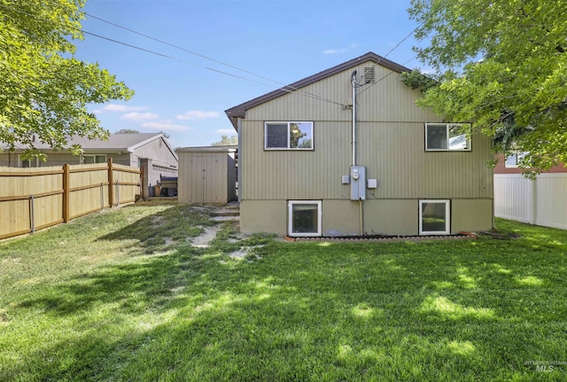 168 W Heyburn Ave, Twin Falls, ID 83301 - rear view of house featuring a fenced backyard and a storage shed
