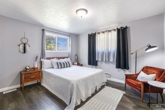 168 W Heyburn Ave, Twin Falls, ID 83301 - bedroom with baseboards and dark wood-type flooring