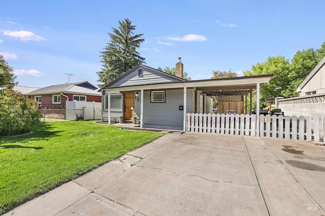168 W Heyburn Ave, Twin Falls, ID 83301 - view of front facade featuring driveway, a chimney, and an attached carport
