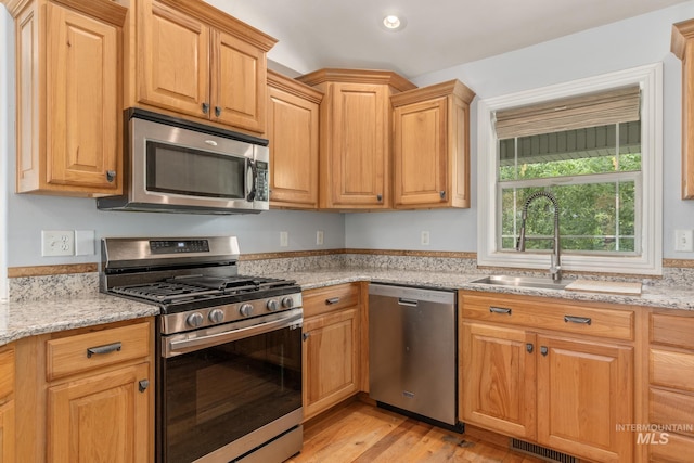 200 W Commons Rd, Idaho Falls, ID 83401 - kitchen with appliances with stainless steel finishes, light wood finished floors, recessed lighting, and light stone counters