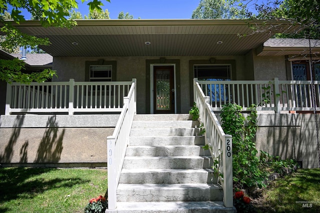 200 W Commons Rd, Idaho Falls, ID 83401 - doorway to property featuring stucco siding and a porch