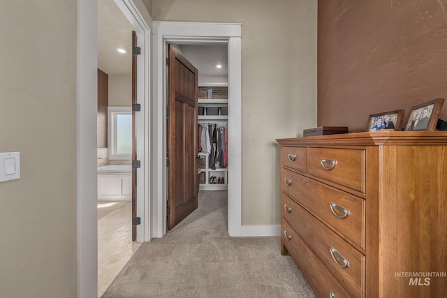 hallway featuring light carpet