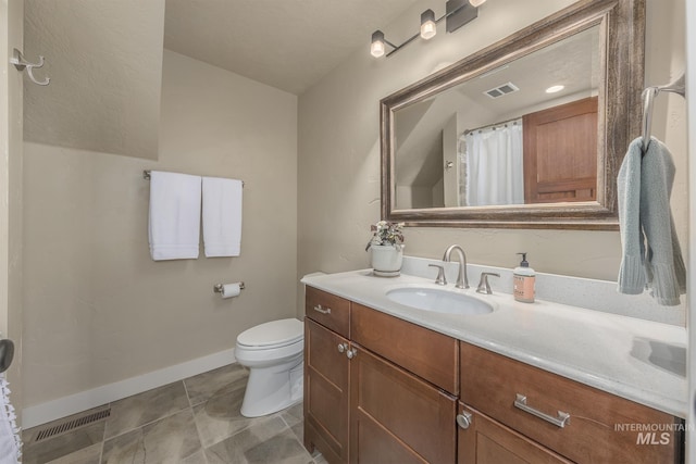 bathroom with vanity, toilet, baseboards, curtained shower, and tile patterned floors