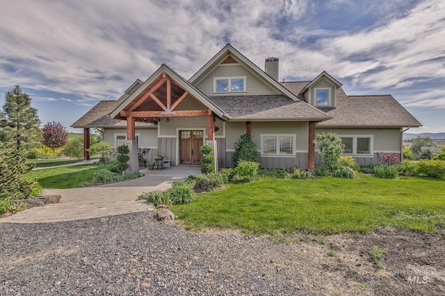 craftsman house with a chimney, a front yard, and roof with shingles
