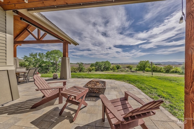 view of patio with a fire pit