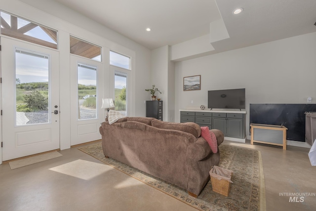 living area with concrete floors, plenty of natural light, and recessed lighting