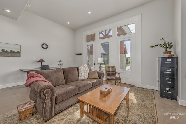 living area with baseboards, recessed lighting, a desk, french doors, and concrete flooring