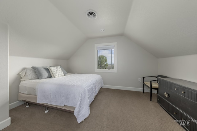 carpeted bedroom featuring vaulted ceiling and baseboards