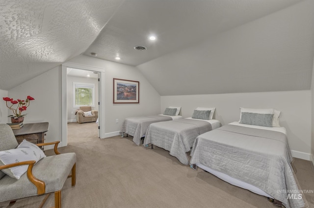 bedroom featuring vaulted ceiling, light carpet, and baseboards