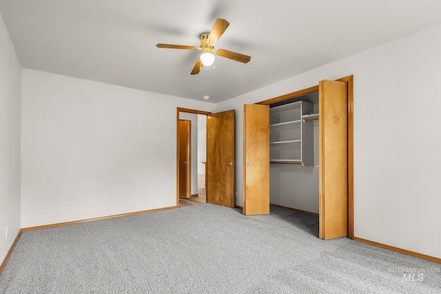 unfurnished bedroom with a closet, baseboards, carpet floors, and ceiling fan