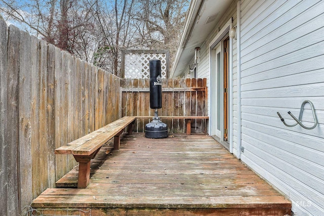 wooden terrace featuring fence