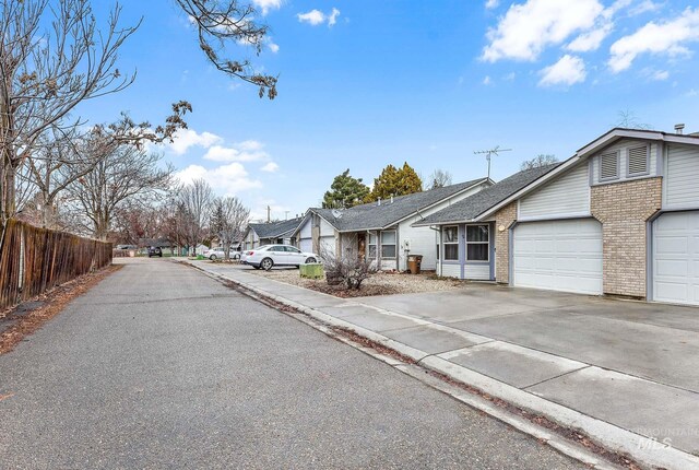 view of street featuring a residential view, curbs, and sidewalks