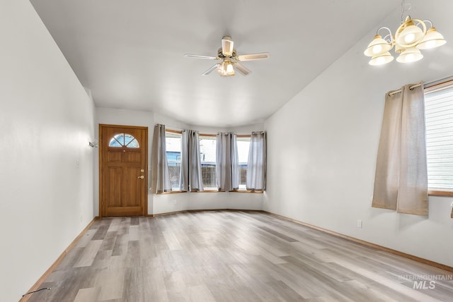 entryway featuring baseboards, ceiling fan with notable chandelier, and light wood finished floors