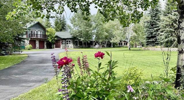 76 Rogers Ln, Mccall, ID 83638 - view of grassy yard with asphalt driveway and an attached garage
