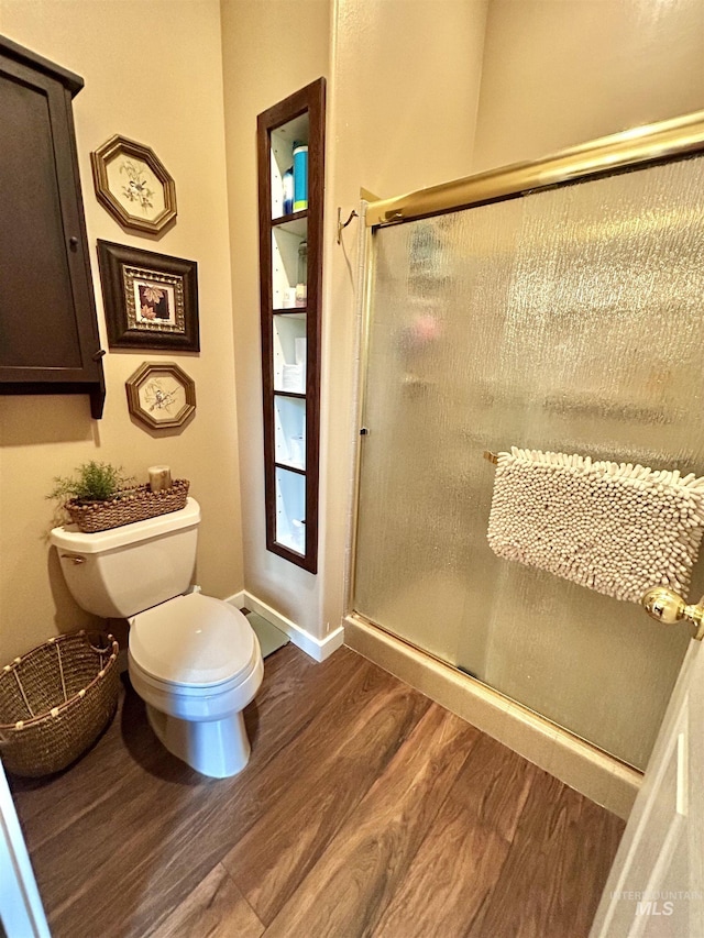 76 Rogers Ln, Mccall, ID 83638 - full bath featuring wood finished floors, toilet, a stall shower, and baseboards