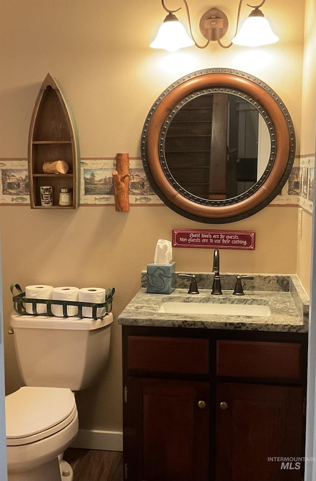 76 Rogers Ln, Mccall, ID 83638 - bathroom featuring vanity, toilet, wood finished floors, and baseboards
