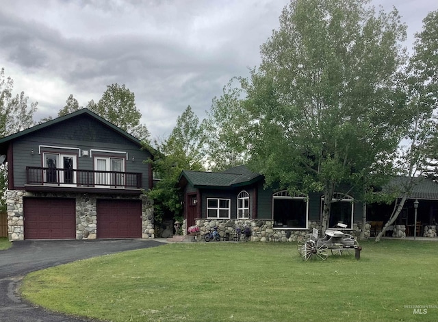 76 Rogers Ln, Mccall, ID 83638 - view of front facade featuring stone siding, a front lawn, asphalt driveway, and an attached garage