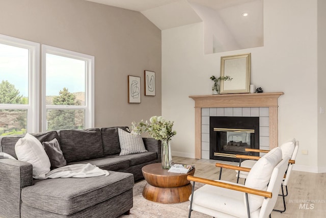 4335 W Quail Ridge Dr, Boise, ID 83703 - living area with wood finished floors, a tiled fireplace, and vaulted ceiling