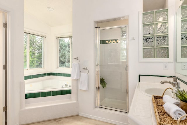 4335 W Quail Ridge Dr, Boise, ID 83703 - bathroom featuring a garden tub, a shower stall, vaulted ceiling, and wood finished floors