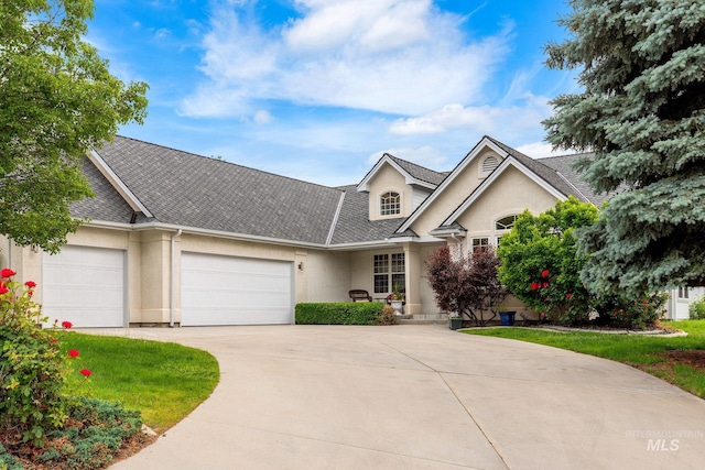 4335 W Quail Ridge Dr, Boise, ID 83703 - view of front facade featuring a garage, stucco siding, driveway, and roof with shingles