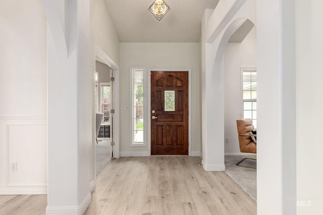 4335 W Quail Ridge Dr, Boise, ID 83703 - entryway with light wood-type flooring, arched walkways, and healthy amount of natural light