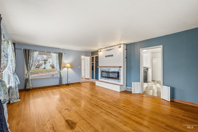 unfurnished living room with hardwood / wood-style flooring