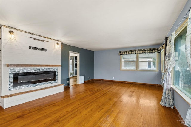 unfurnished living room featuring hardwood / wood-style floors